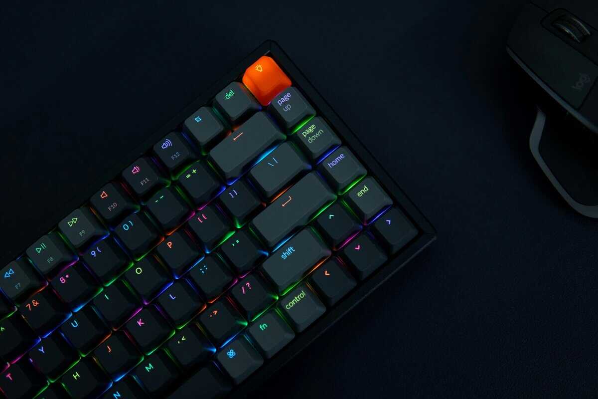 Compact mechanical keyboard with the best switches for gaming featuring RGB lighting and orange escape key