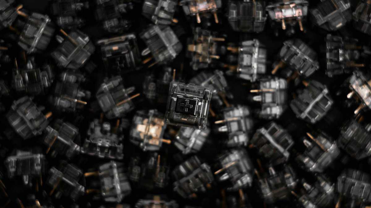 Best switches for gaming showing a pile of mechanical keyboard switches with one in focus