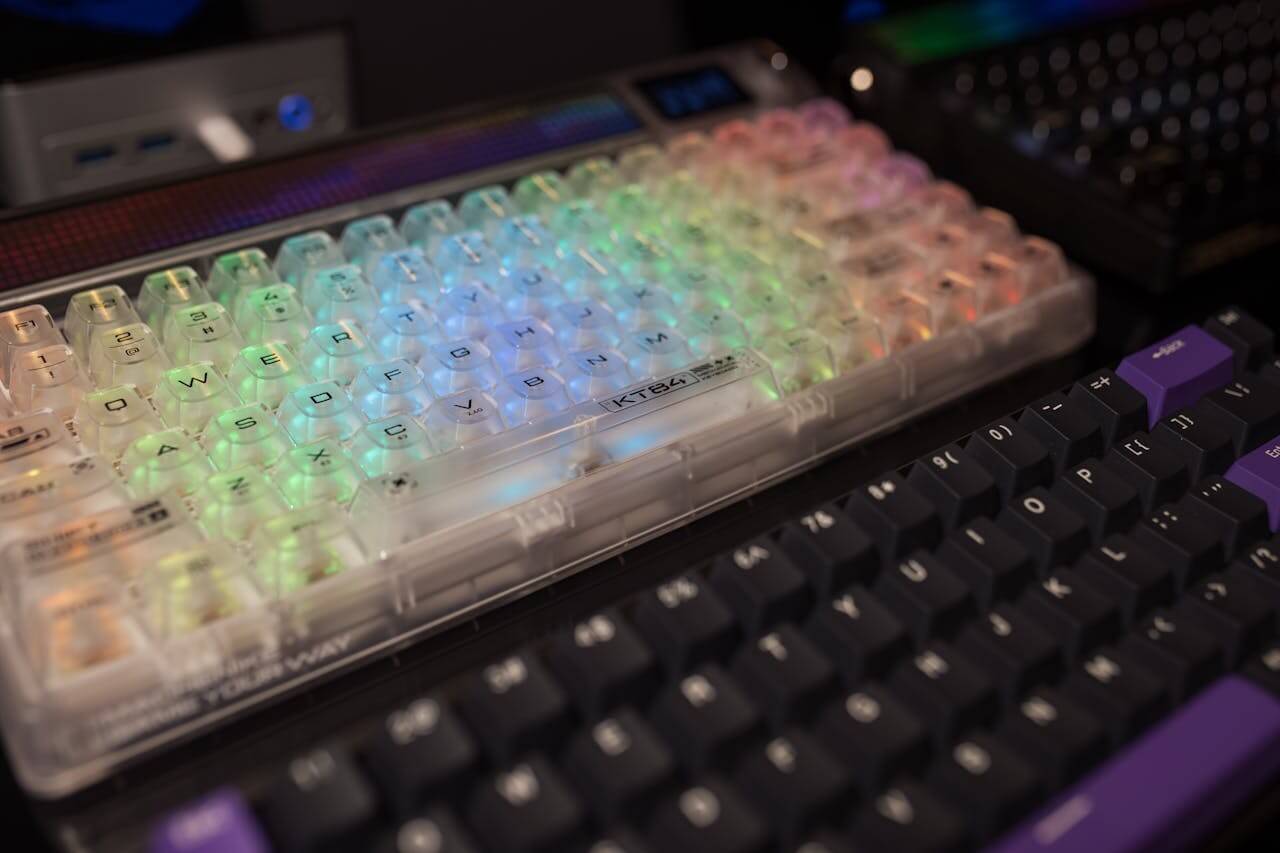 Vibrant RGB mechanical keyboards with transparent and black keycaps, perfect for gaming setups.