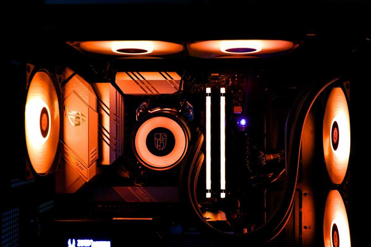 Best gaming PC under $1000 with ASUS TUF motherboard, Deepcool AIO cooler, and orange RGB lighting theme
