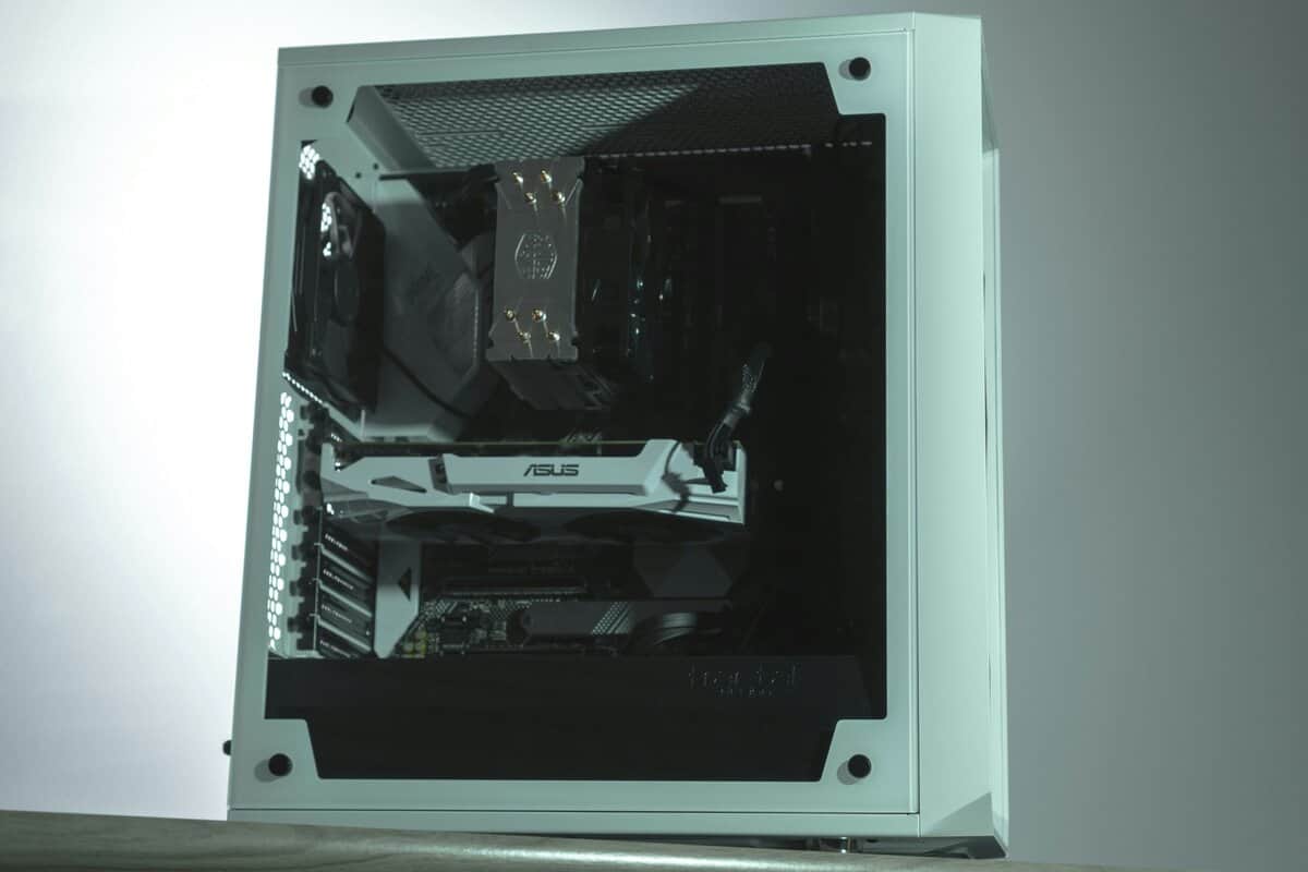 Seafoam green gaming PC case interior showing ASUS motherboard, tower cooler, GPU, and rear exhaust fan