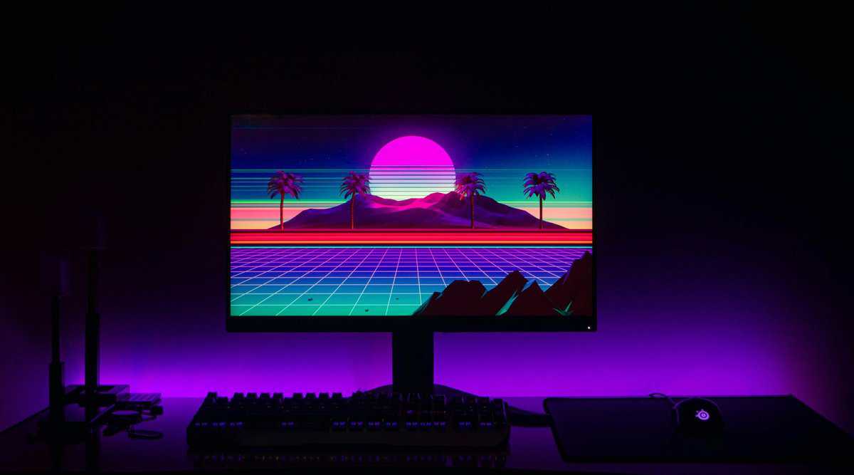 440p gaming monitor with synthwave wallpaper and purple ambient lighting