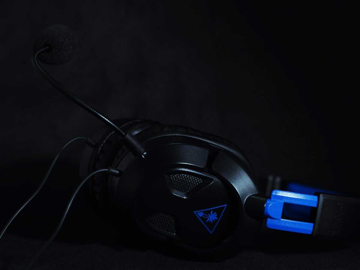 Best PS5 headset from Turtle Beach with blue flip-to-mute microphone and wired connection on a dark background