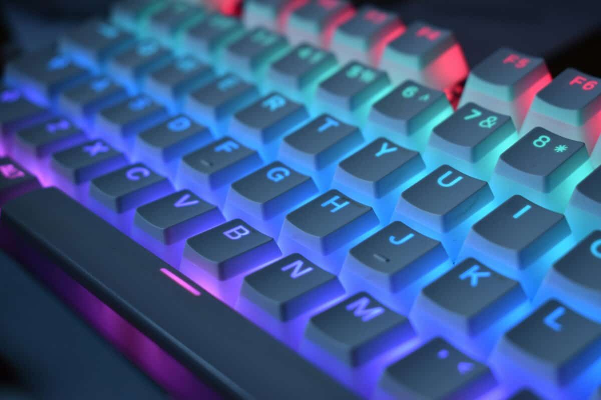 Close-up of the best budget keyboard for gaming showing RGB backlit mechanical keys with blue and pink lighting