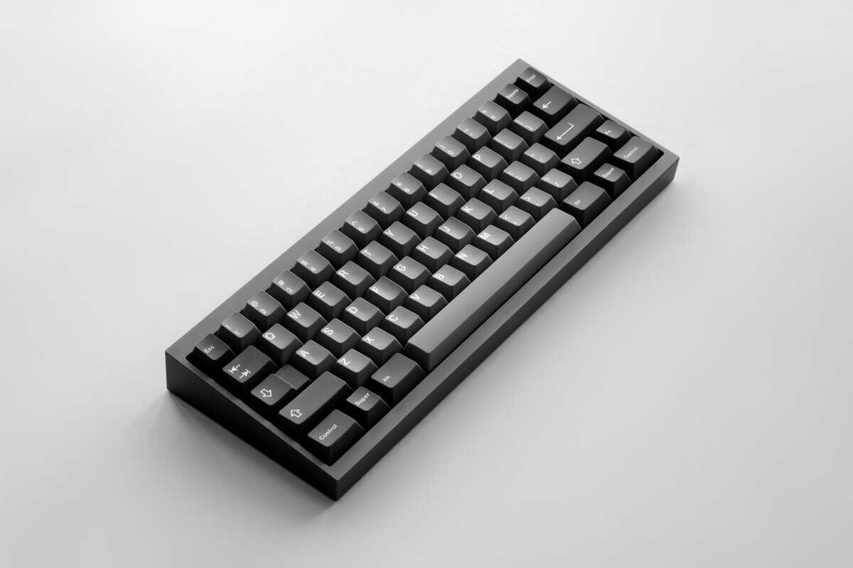 A 60% keyboard with black keycaps on a white background showcasing the compact layout.
