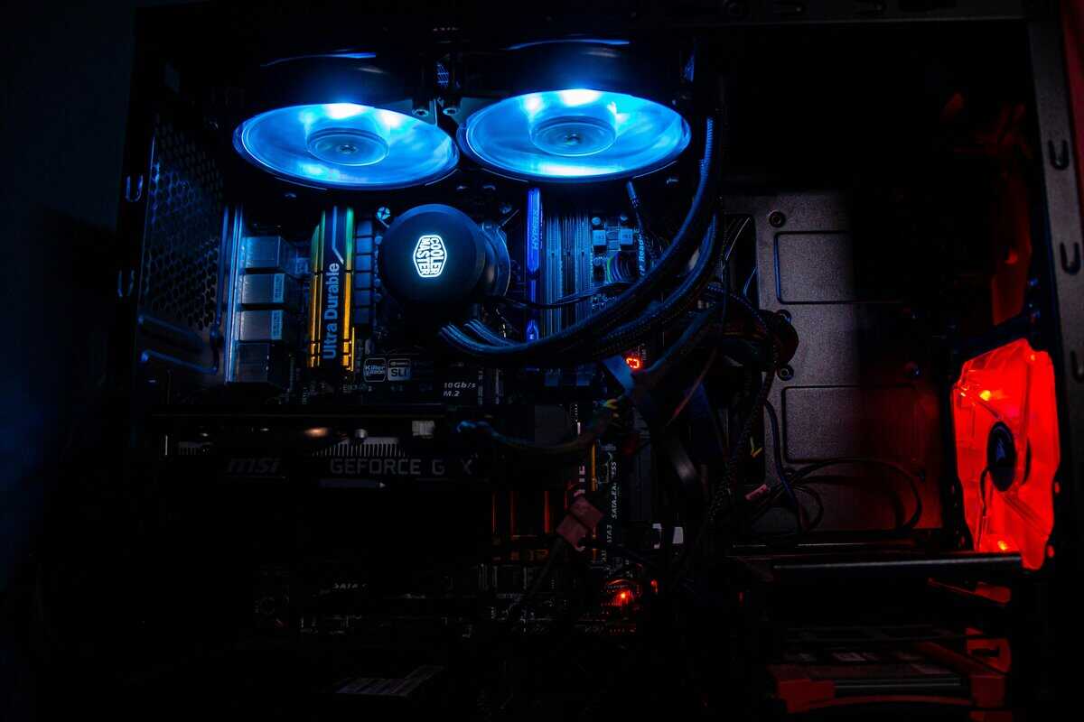 How to build a gaming PC interior with Cooler Master AIO liquid cooler, blue LED radiator fans, Gigabyte Ultra Durable motherboard, MSI GeForce graphics card, and red case fan