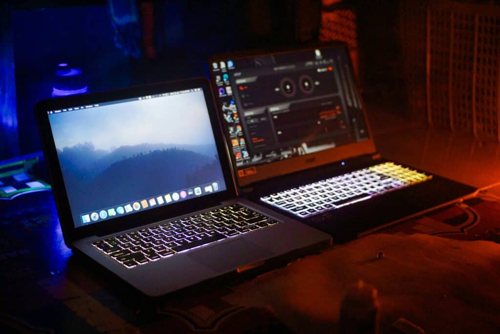 wo laptops compared side by side showing the best cheap laptop for gaming with RGB keyboard next to a standard laptop
