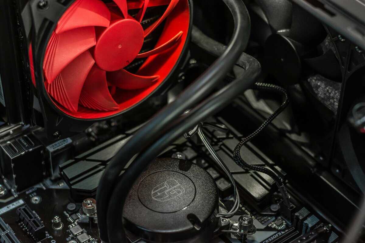 AIO liquid cooler with pump block mounted on CPU and red radiator fan, an effective upgrade for maintaining normal CPU temp during intense gaming