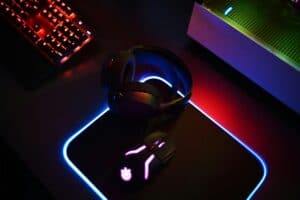 Top gaming headsets for every budget displayed on a desk with RGB lighting