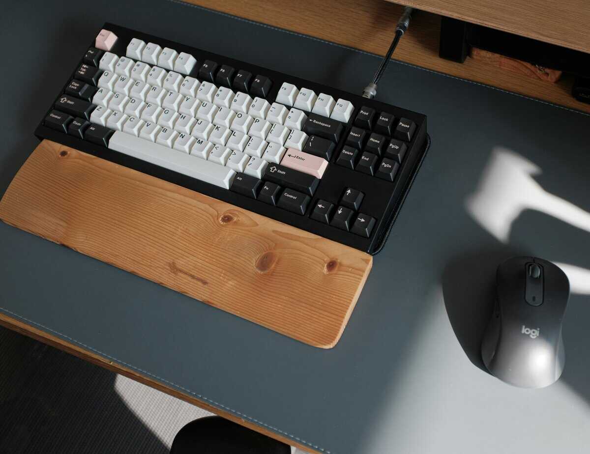 Wooden wrist rest for a keyboard paired with a mechanical keyboard and mouse on a clean gaming desk