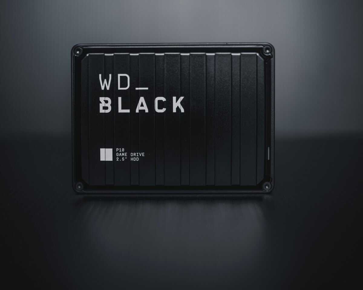 WD_BLACK P10 Game Drive 2.5-inch HDD on a dark reflective surface, a popular external drive for Xbox Series X storage expansion