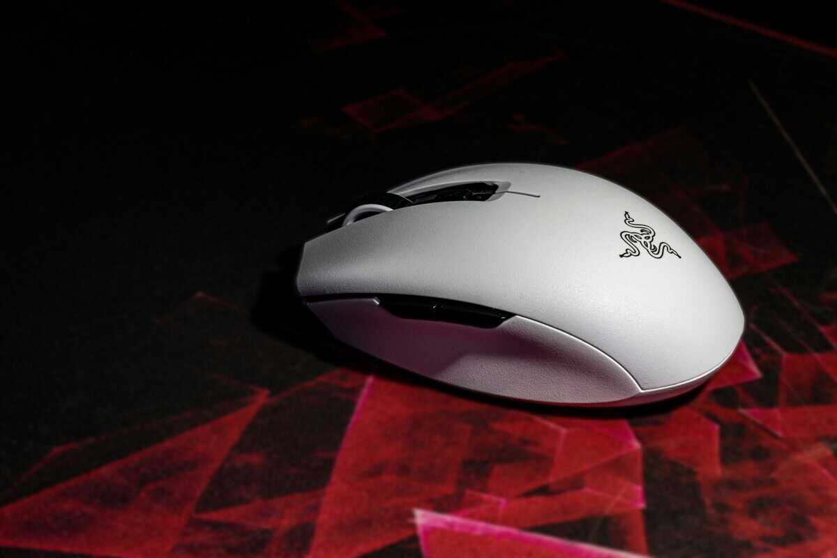 White Razer gaming mouse on a dark mousepad showing the best bluetooth mouse for gaming in a compact wireless design