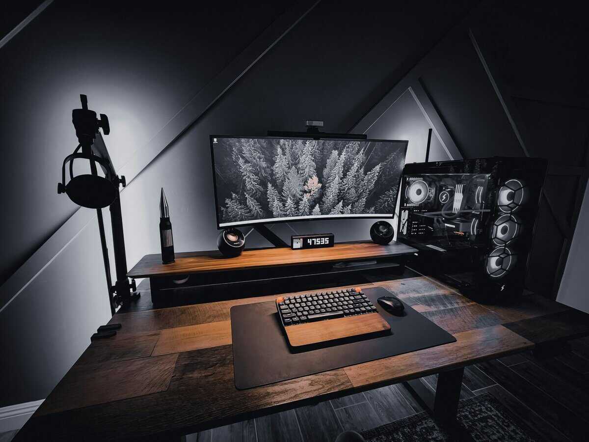 Multi-monitor setup with a large central display, showing the productivity side of the 27-inch vs 32-inch monitor question