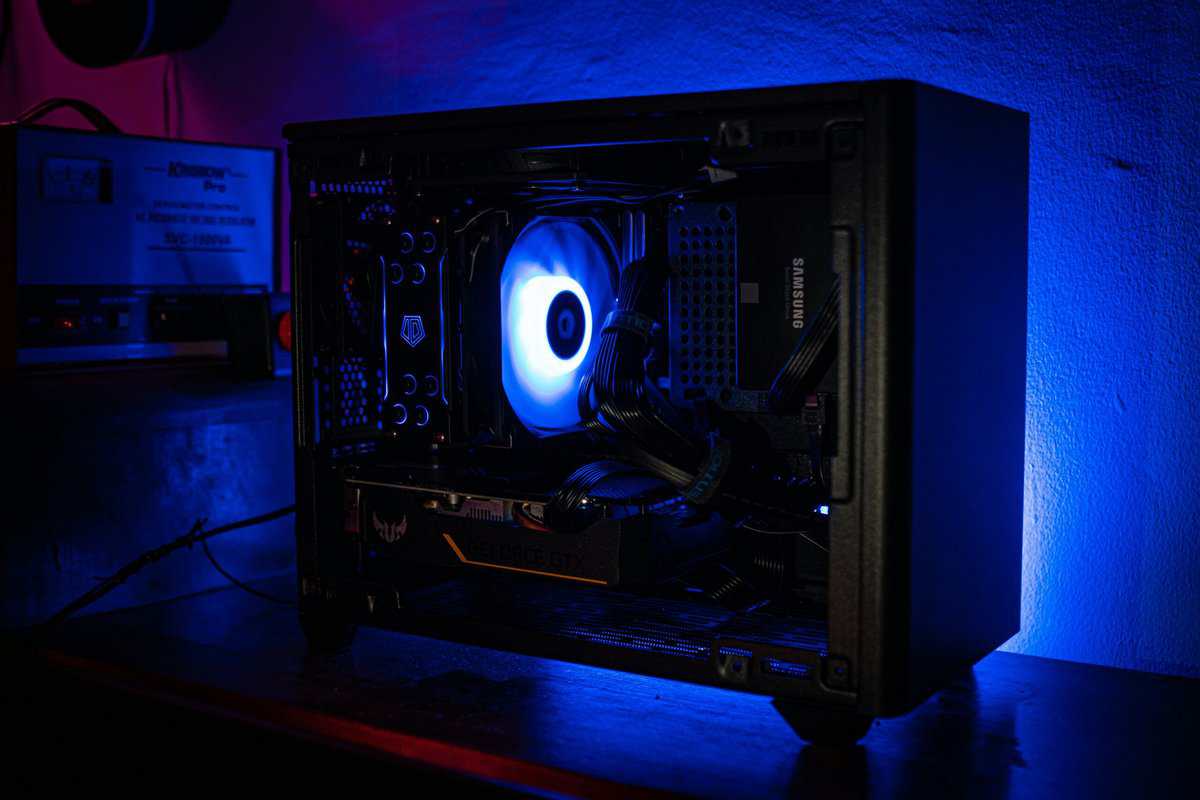 Inside a best budget prebuilt gaming PC showing the GPU, CPU cooler fan, Samsung SSD, and cable management with blue LED lighting