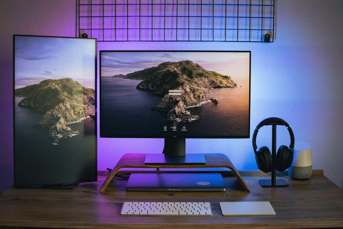 Clean dual-monitor desk setup with landscape wallpaper and headphone stand, illustrating how a 144hz vs 240hz choice affects your daily gaming experience