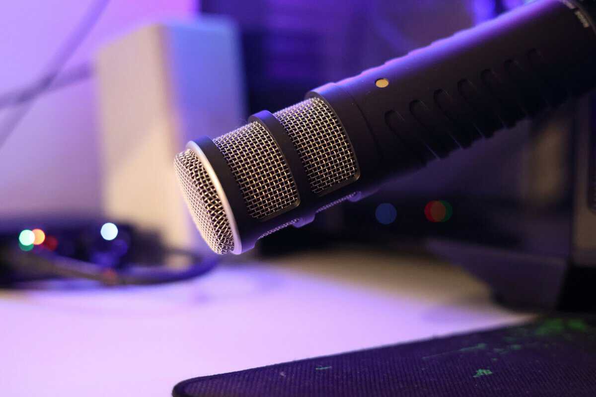 Close-up of a dynamic microphone at a gaming desk, the kind of mic most guides target when teaching how to test a microphone on PC