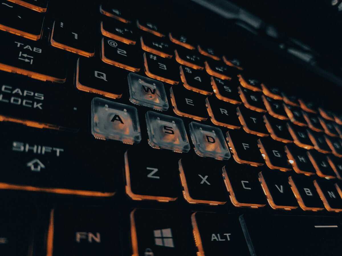 WASD keys on a gaming laptop keyboard with orange backlighting, highlighting the build quality expected from the best gaming laptop under $1500