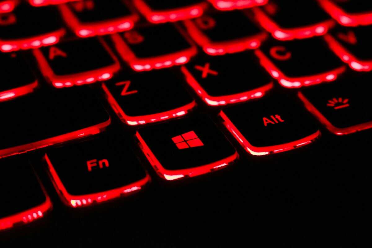 Close-up of a gaming laptop keyboard with red RGB backlighting, a common feature on the best gaming laptop under $1500