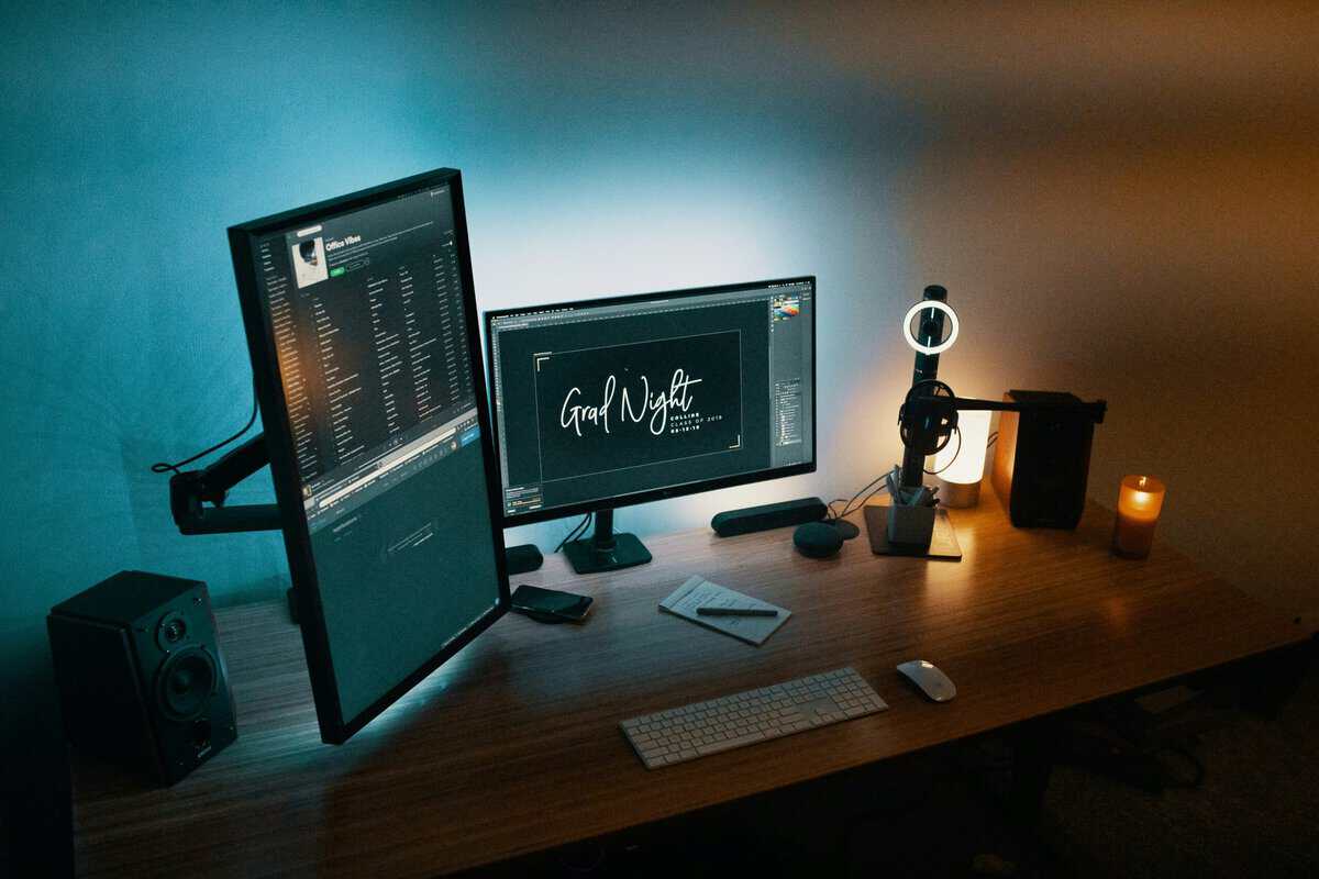 Dual-monitor desk setup with a vertically mounted screen, showing what the best monitor arm unlocks for gamers