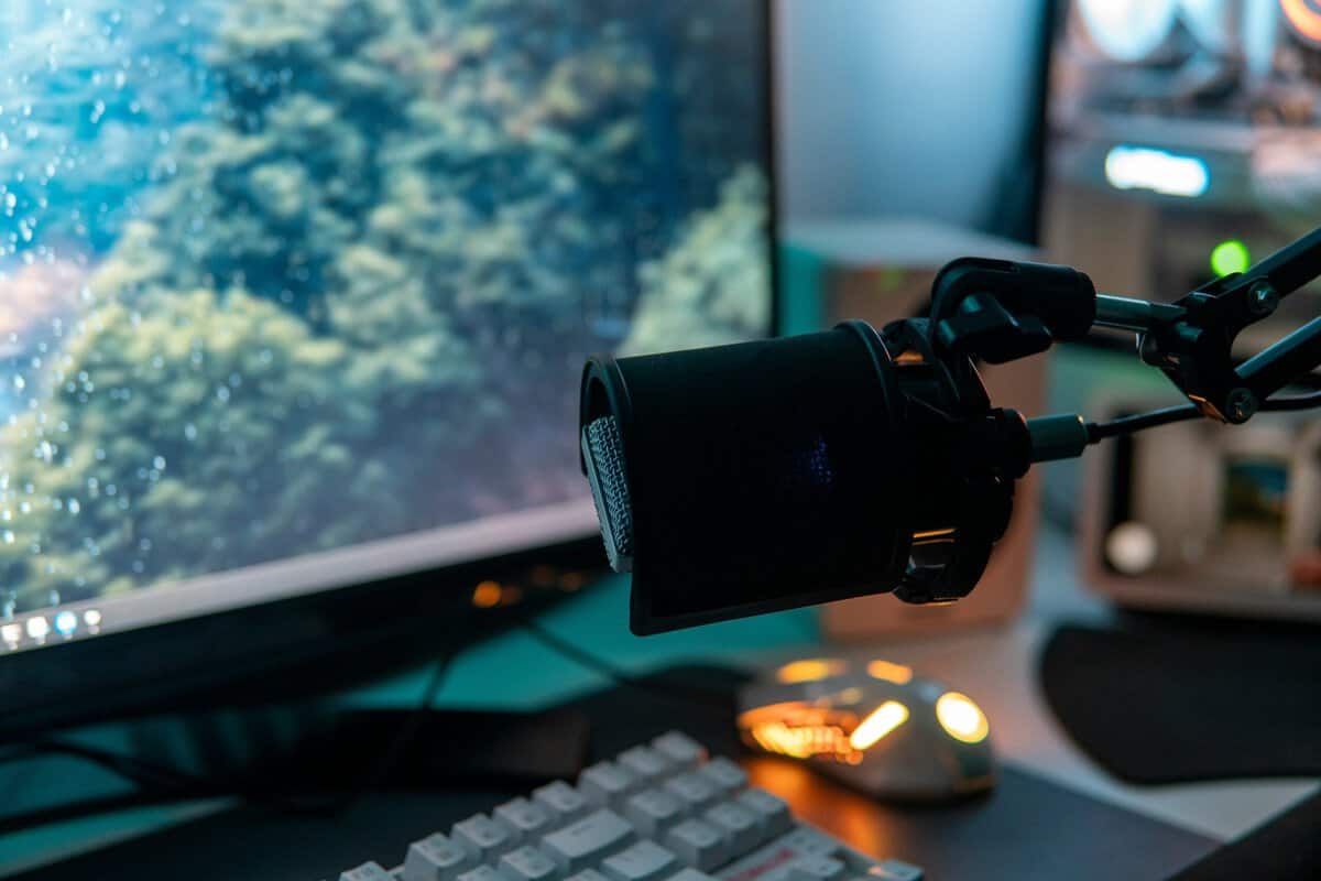 Broadcast microphone on a boom arm at a gaming desk, the setup most people need to test a microphone on PC