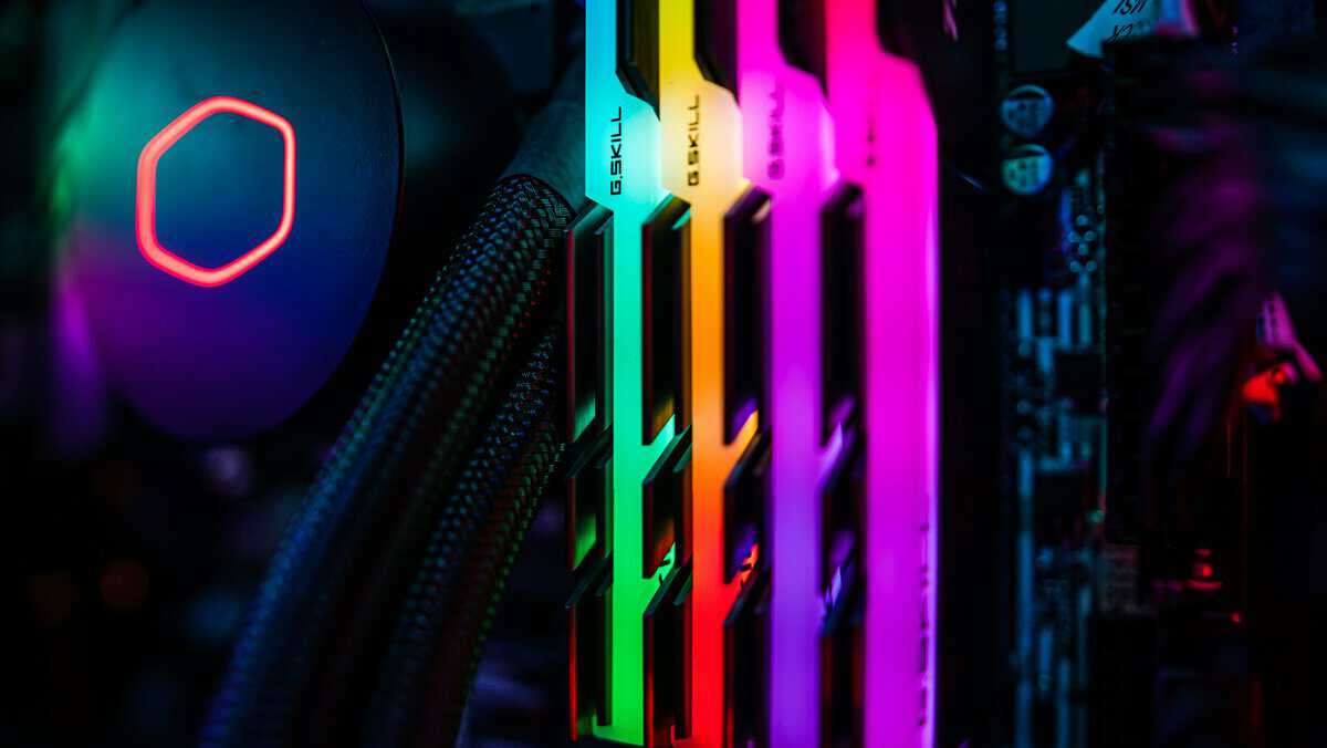 Four RGB RAM sticks glowing beside a liquid cooler, the kind of flashy kit often compared in DDR4 vs DDR5 for gaming builds