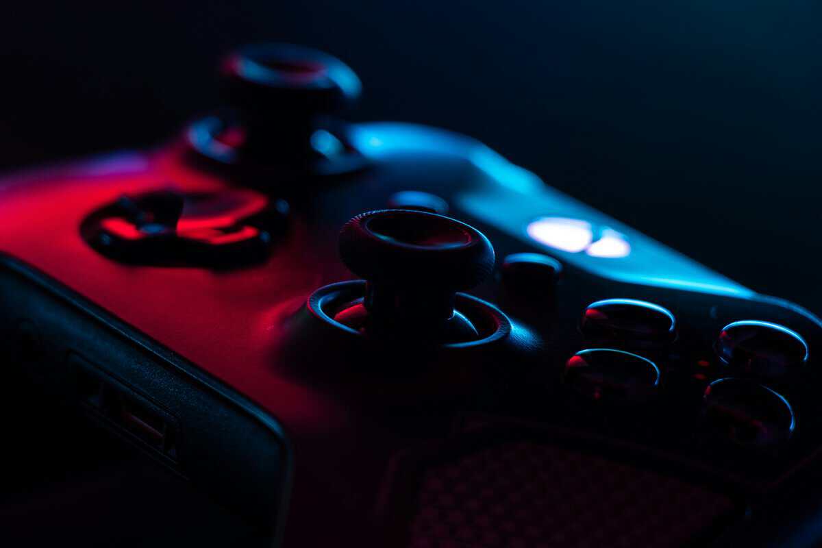 Person gaming on a couch with a wireless controller, illustrating comfort that matters when choosing the best controller for Rocket League