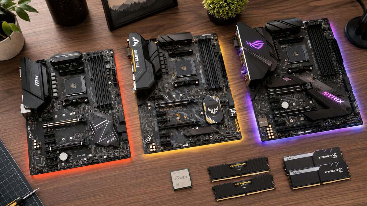 Three AM4 motherboards (MSI, ASUS TUF Gaming, and ASUS ROG Strix) laid out with a Ryzen CPU and DDR4 RAM on a wood desk, comparing the best AM4 motherboard options