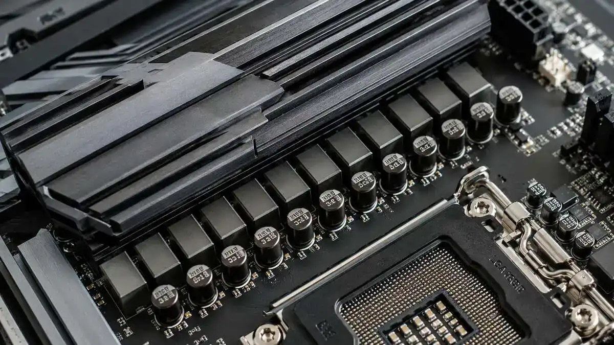 Close-up of a motherboard VRM heatsink and power-delivery components beside the CPU socket, the build quality that defines the best AM4 motherboard