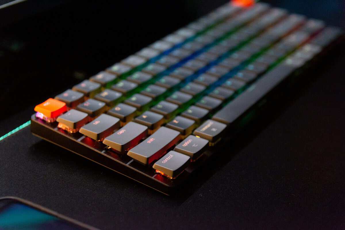 A backlit mechanical gaming keyboard on a dark desk, the kind of board to look for when choosing the best keyboard for Tarkov