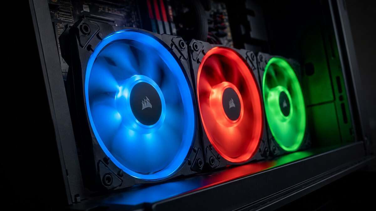 Three of the best RGB case fans glowing blue, red, and green inside a dark gaming PC case