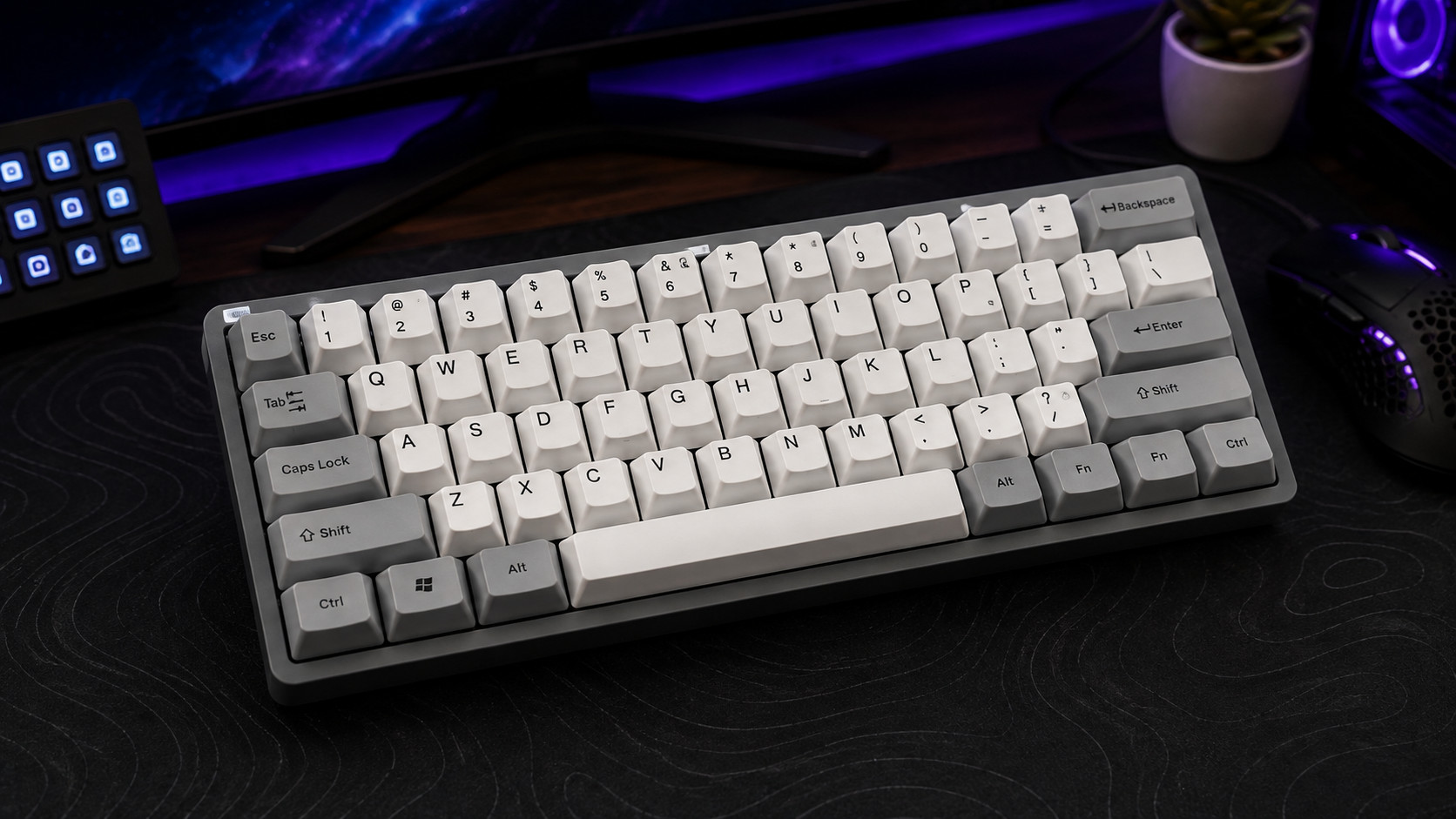 Compact keyboard fitted with an opaque grey and white dye-sublimated set, one of the best keycaps choices when RGB shine-through is not the priority