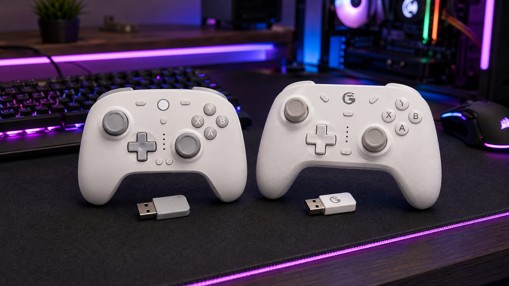 Two white wireless gamepads with their USB dongles on a desk mat, budget contenders in the best hall effect controller field