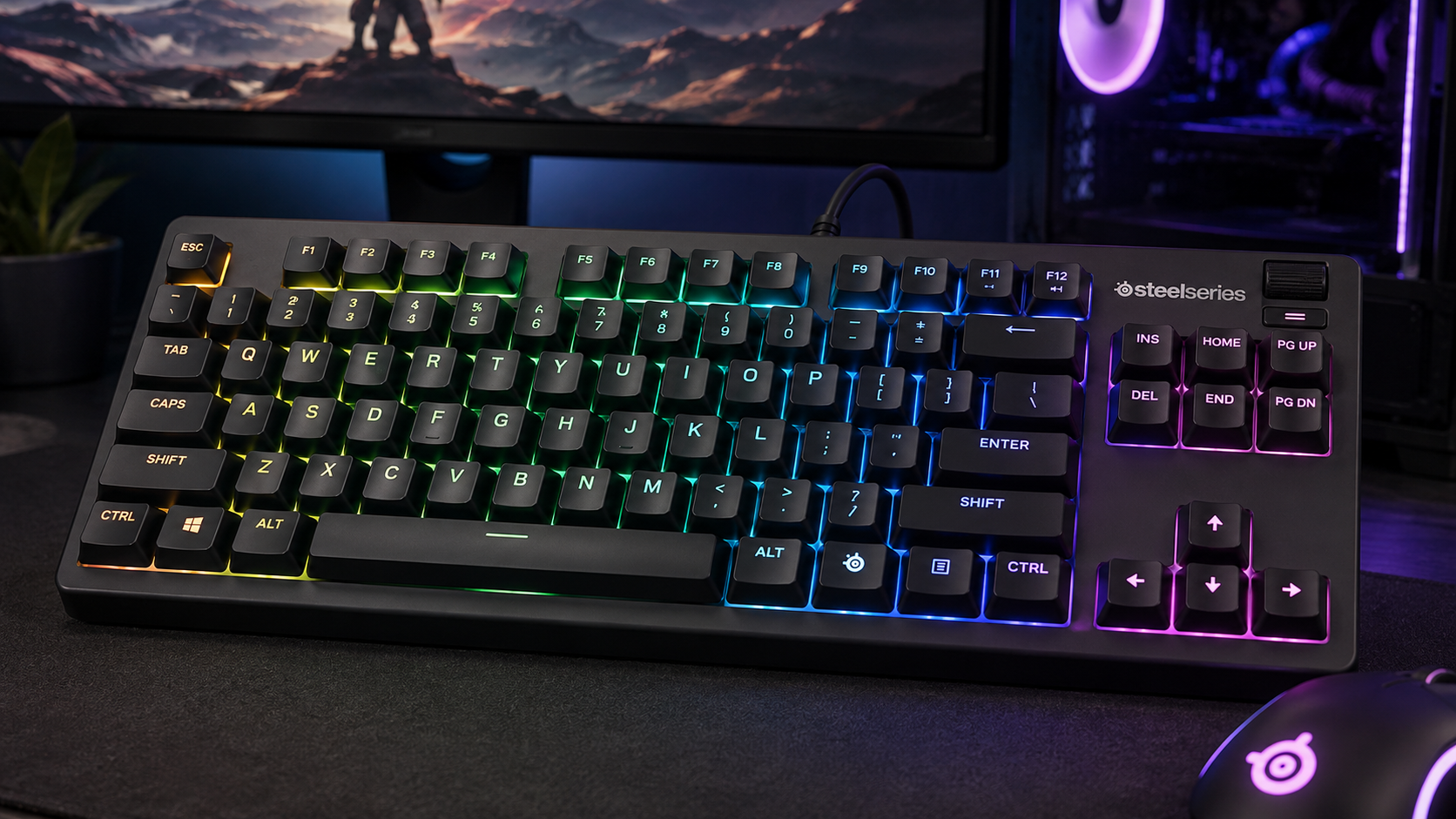 SteelSeries Apex 3 TKL glowing with rainbow backlighting on a dark gaming desk, the kind of budget board that answers what is N key rollover worth in real play