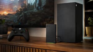 Xbox-branded external drive with a green LED strip standing beside an Xbox Series X console and controller, the capacity-first answer when shopping for the best external SSD for Xbox Series X