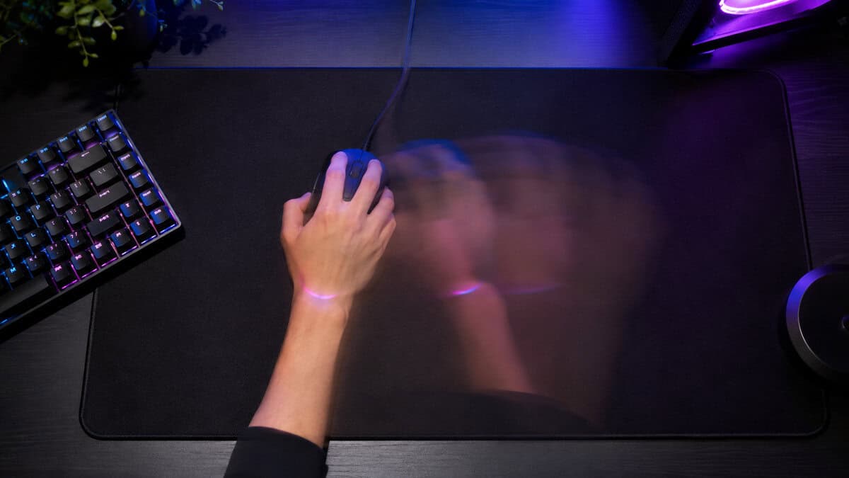 Top-down motion blur of a wide swipe across an extended pad, the desk space the best mouse for Wardogs needs at low sensitivity