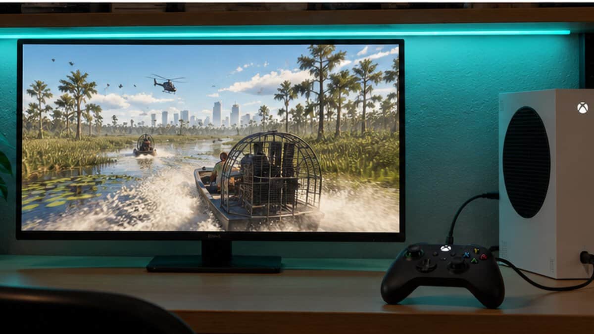 Dorm desk built around the best controller for GTA 6, a wired black gamepad next to a compact white console under a teal shelf light while an airboat races through a swamp on screen