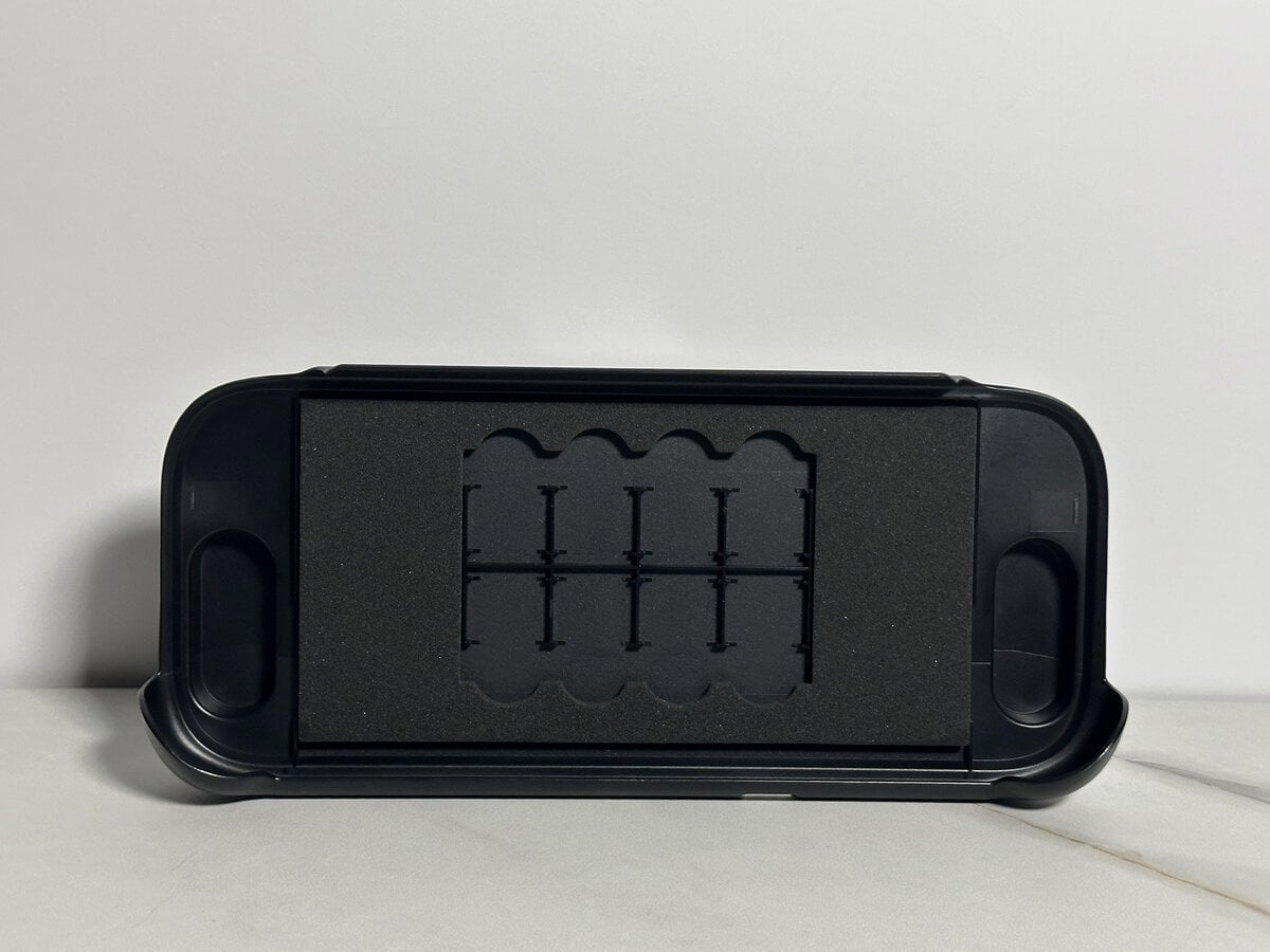 Inside of the JSAUX GoJoy case front cover with foam padding and eight game card slots