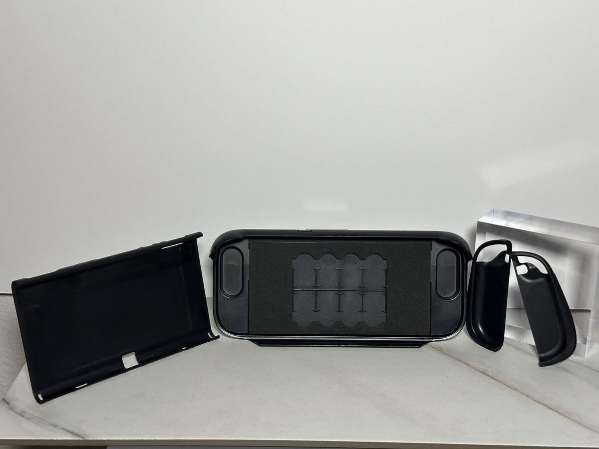 Parts of the JSAUX GoJoy case laid out side by side, including the front cover and the Joy-Con covers with their grips