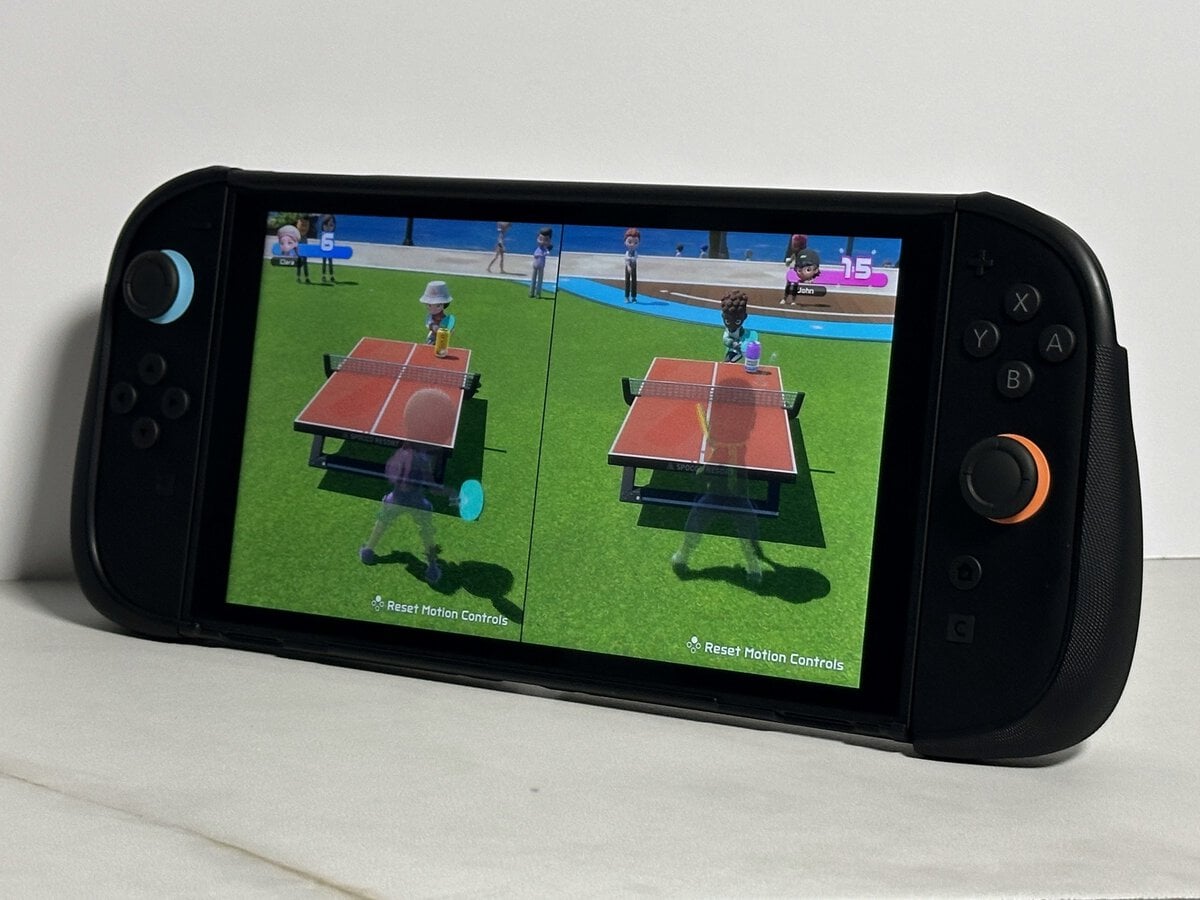 JSAUX GoJoy case on a Switch 2 standing on a white marble surface with a two-player table tennis game on screen