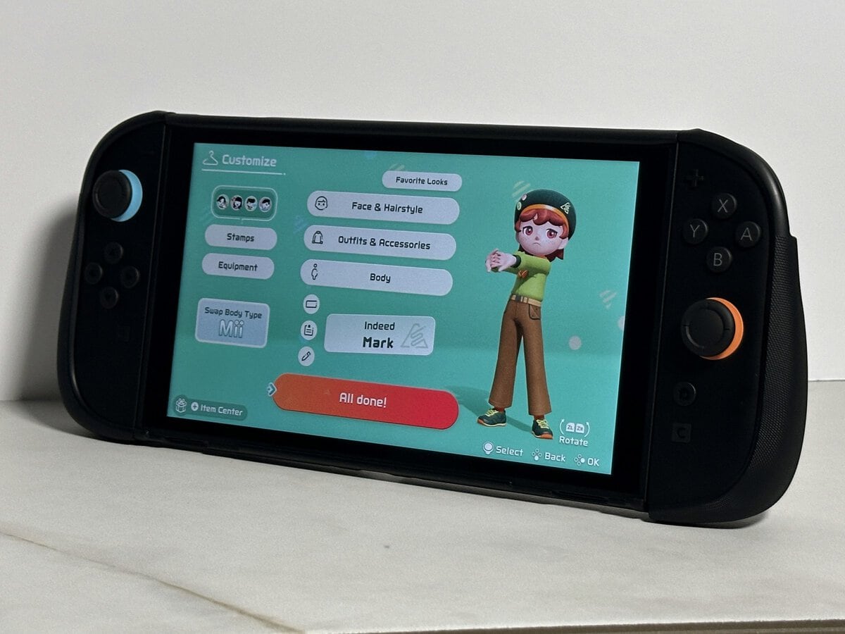 JSAUX GoJoy case on a Switch 2 showing a character customization screen, on a white marble surface