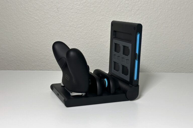 JSAUX 5-in-1 switch 2 pro controller charging dock holding a black Pro Controller and a pair of Joy-Con 2, with its game card panel standing upright